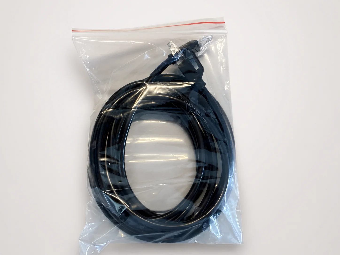 One-meter black Ethernet cable in its protective bag