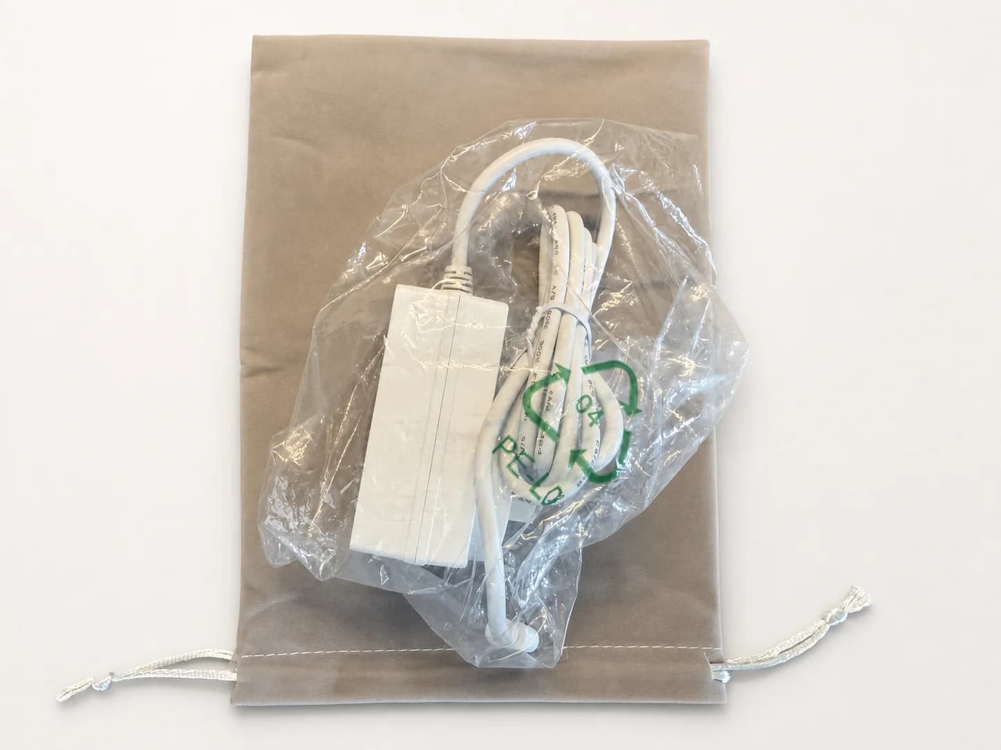 White 27 watt USB-C power supply with its storage pouch